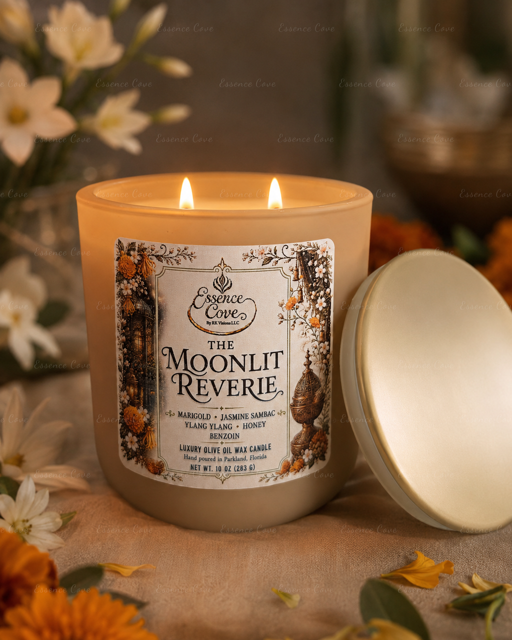 The Moonlit Reverie luxury 10 oz olive oil wax candle with dual lit wicks in a sand-colored matte glass jar, surrounded by raw honey, Jasmine and marigolds by Essence Cove.