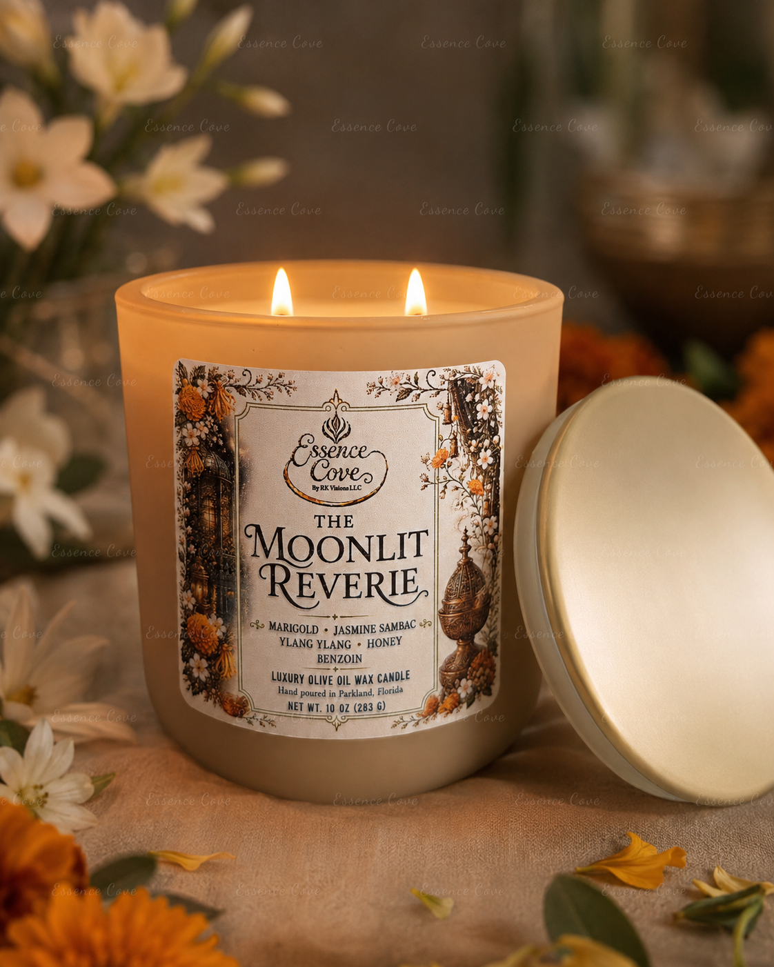 The Moonlit Reverie luxury 10 oz olive oil wax candle with dual lit wicks in a sand-colored matte glass jar, surrounded by raw honey, Jasmine and marigolds by Essence Cove.