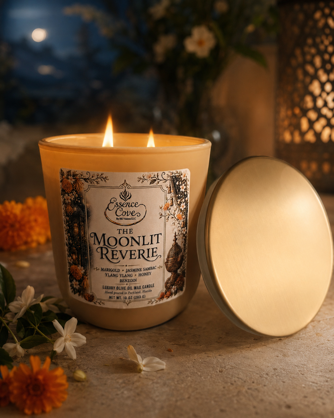 The Moonlit Reverie luxury 10 oz olive oil wax candle with dual lit wicks in a sand-colored matte glass jar, surrounded by raw honey, Jasmine and marigolds by Essence Cove.