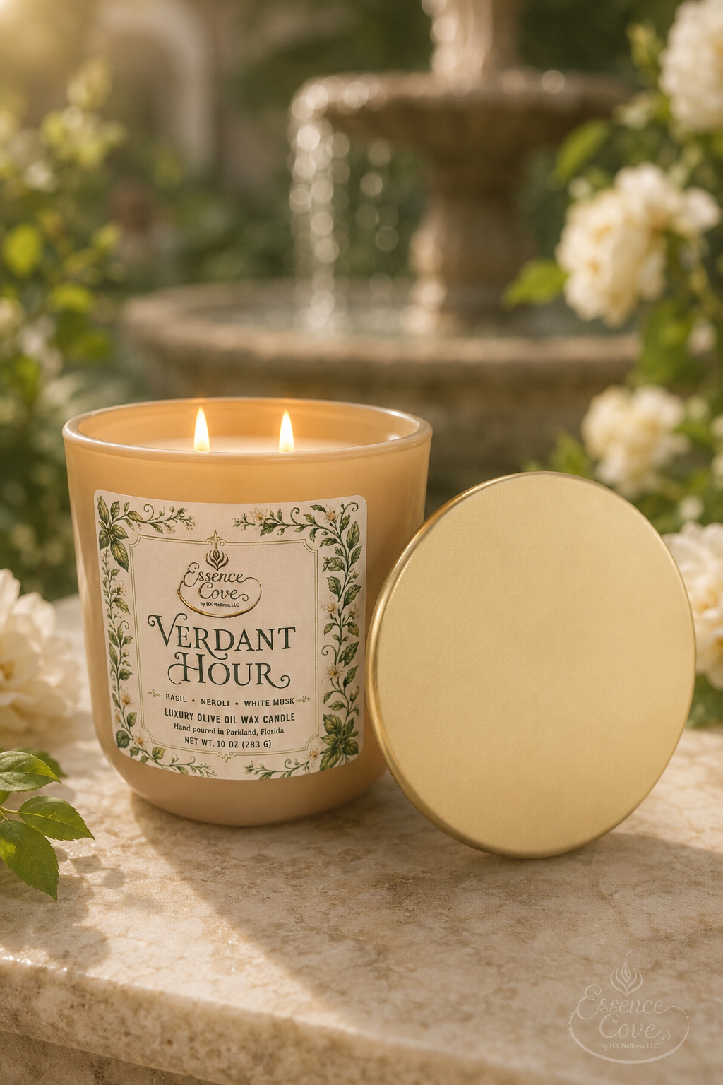 Essence Cove Verdant Hour 10 oz olive oil wax candle with double wick and gold lid surrounded by fresh basil and white flowers.